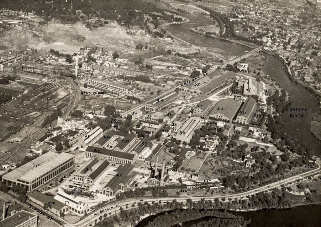 Aerial view of government buildings and nearby factories next to the Charles River.