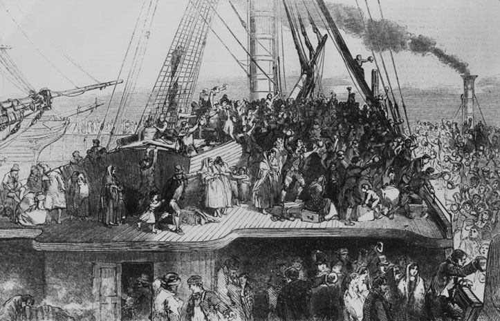 An extremely crowded ship leaving port, with many people huddled on the deck and underneath.