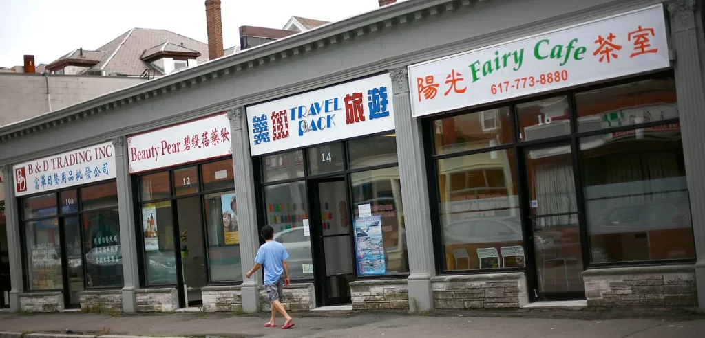 A row of Asian-owned businesses with signs in Chinese or Korean as well as English.
